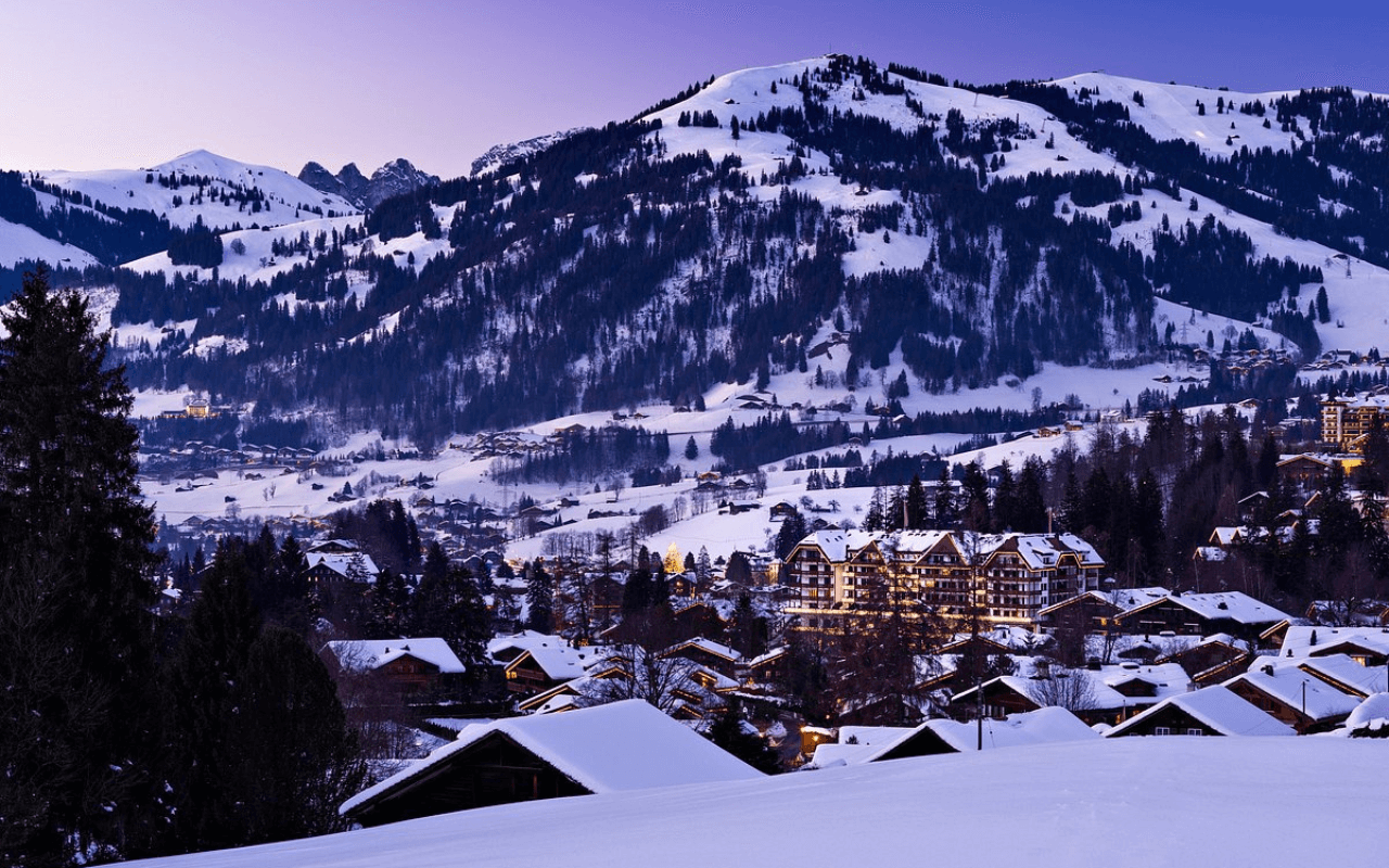 view of villages and mountains with snow on top