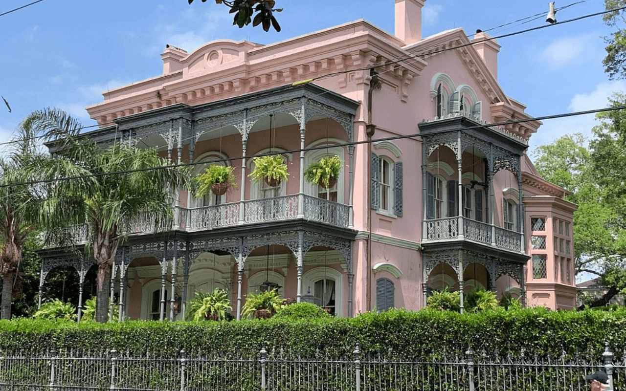pink house with greenery around it