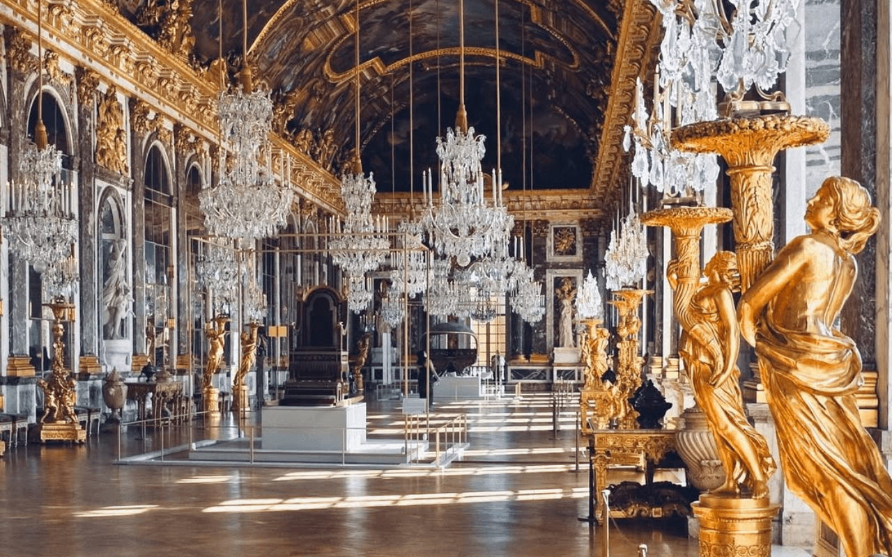 room with chandeliers and gold statues