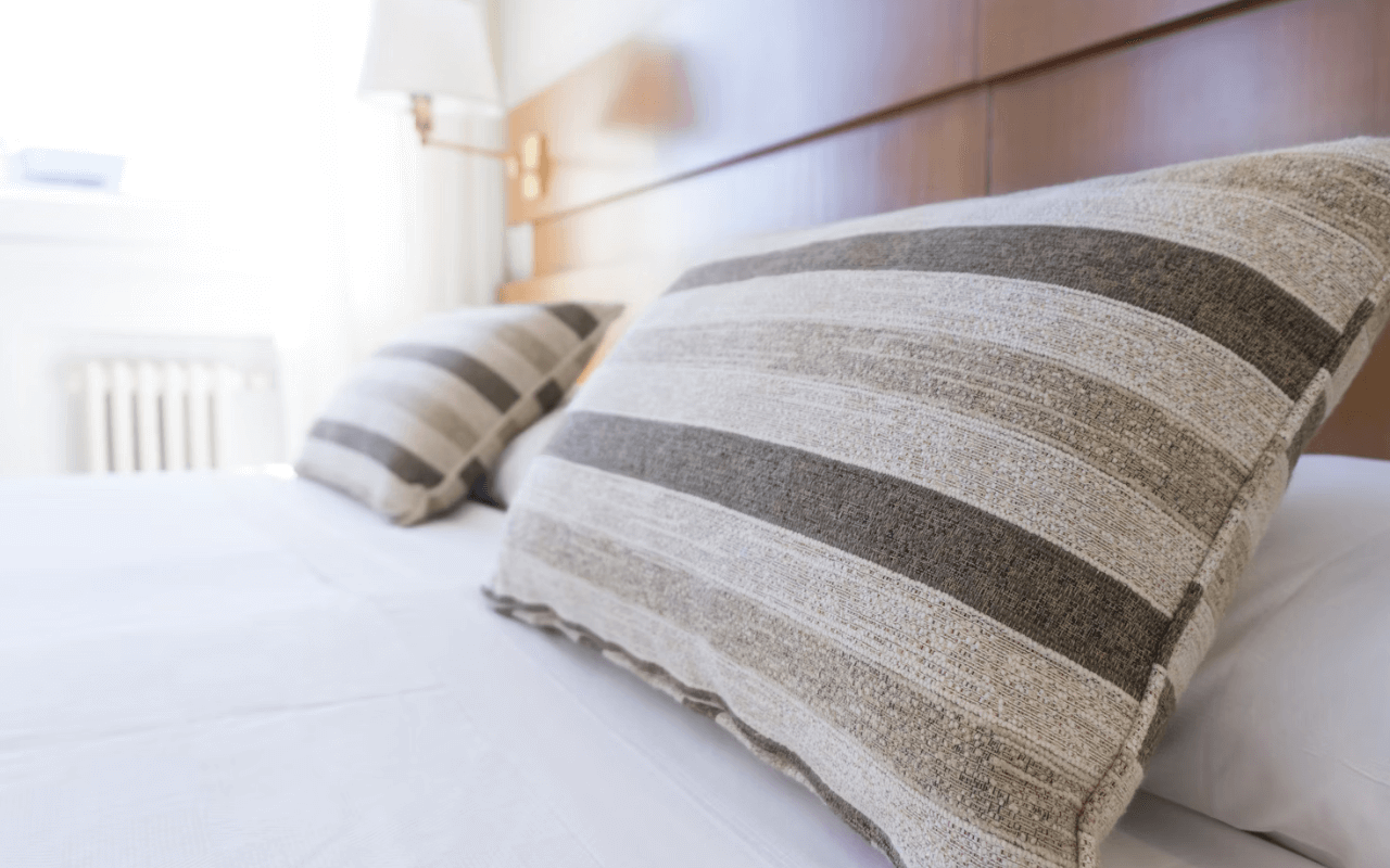2 striped pillows on a bed