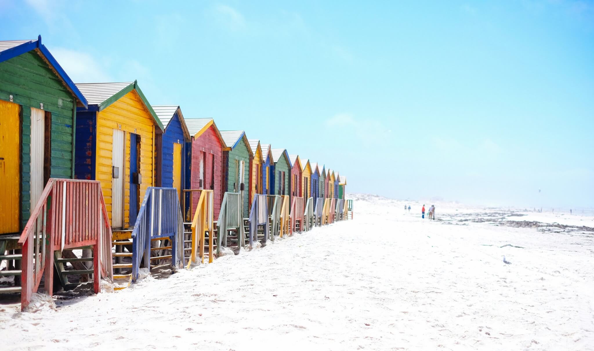 Colorful beach houses along scenic coastline at adventure travel destination