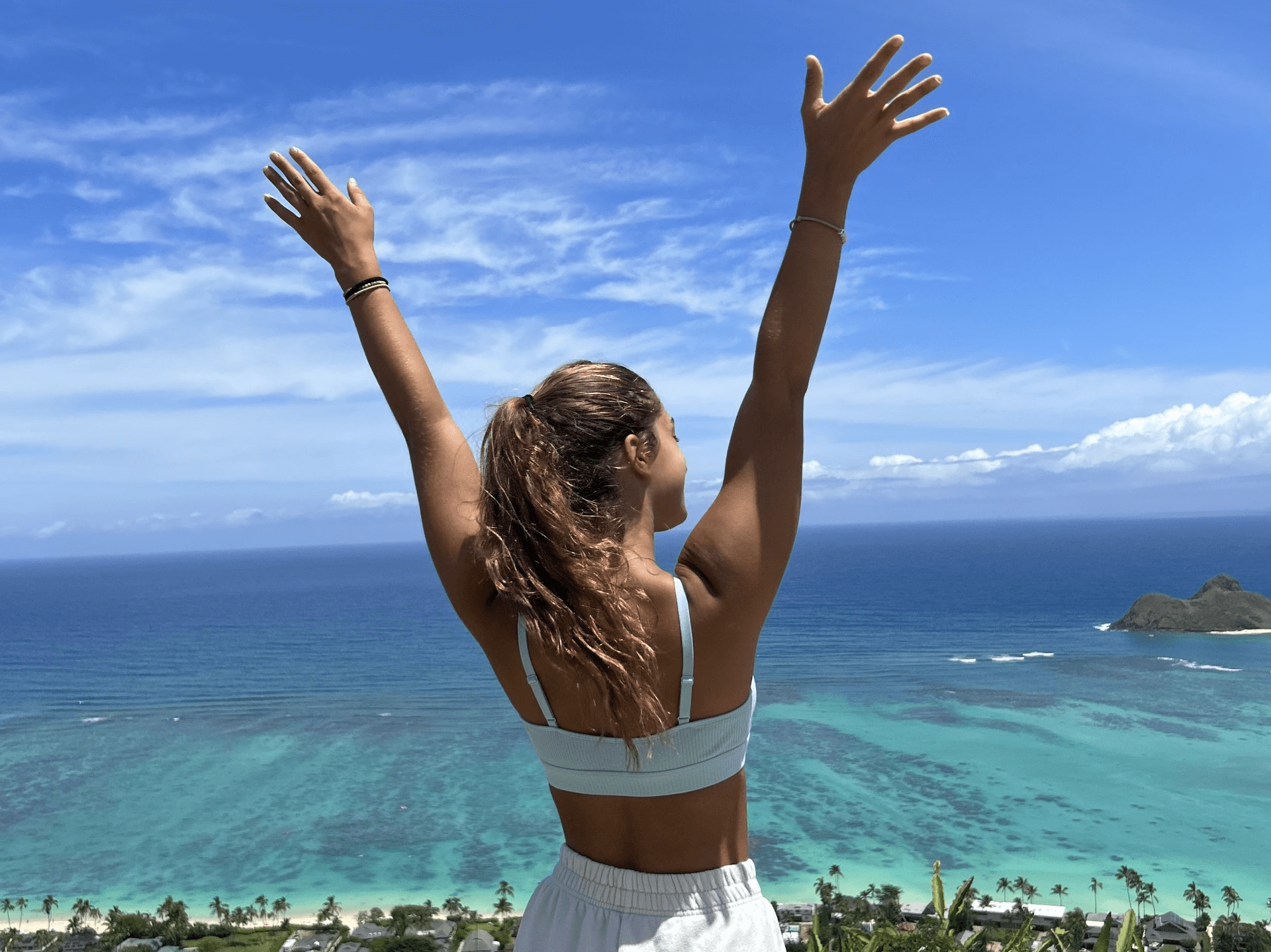 girl raising arms in the air