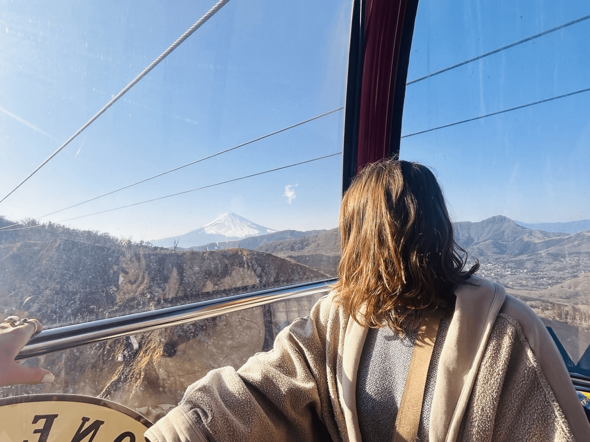 back side of girl looking out towards the mountains