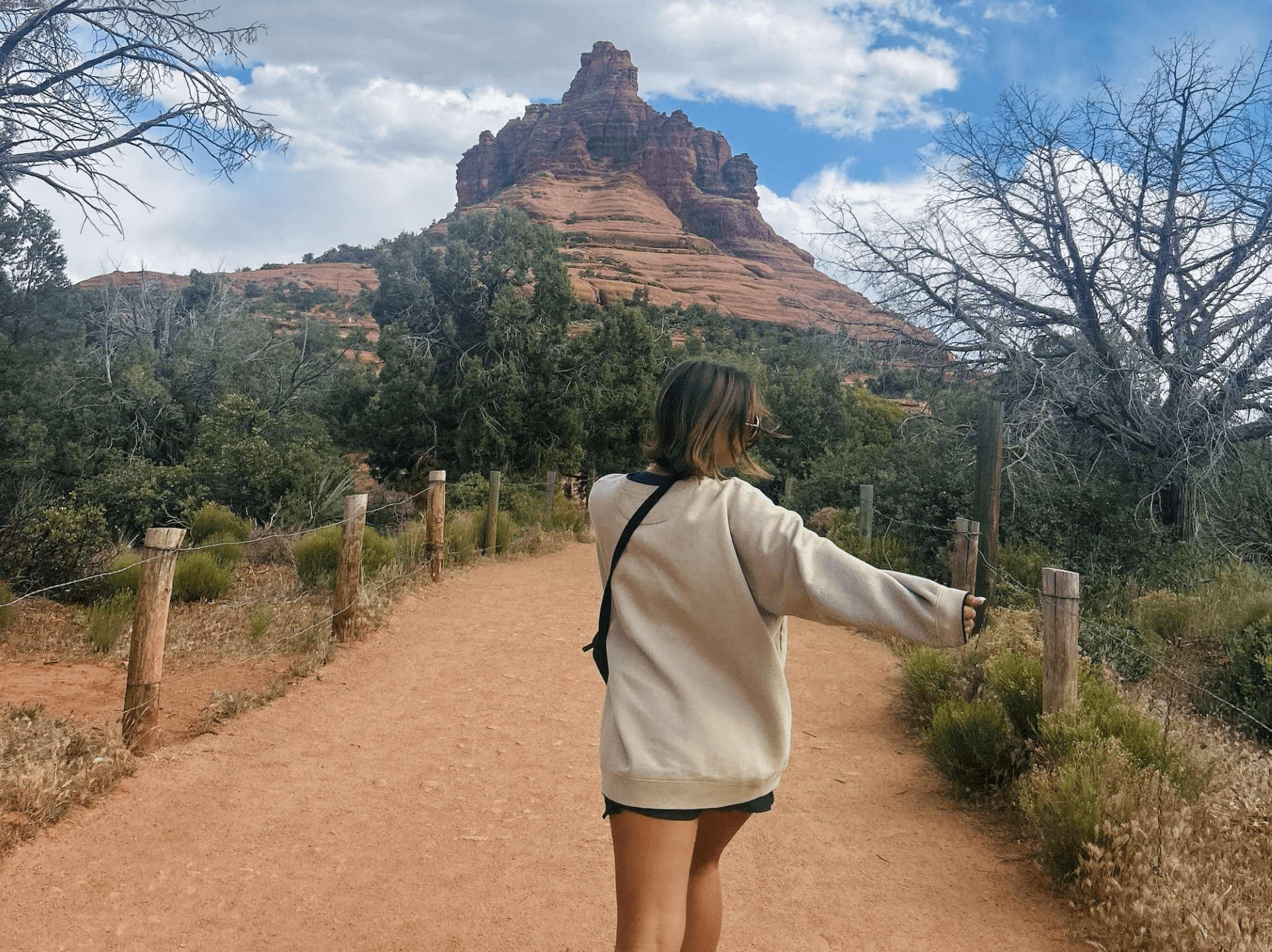 girl walking up to the red rocks