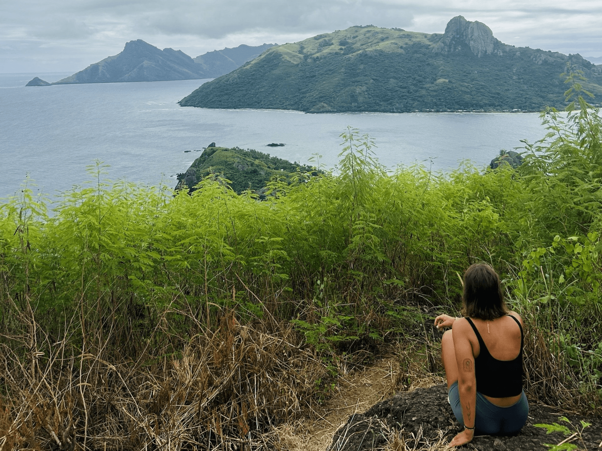 girl looking towards water and mountains on a hike