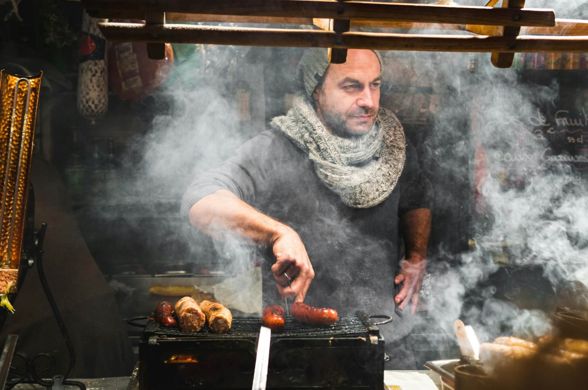 man grilling sausage