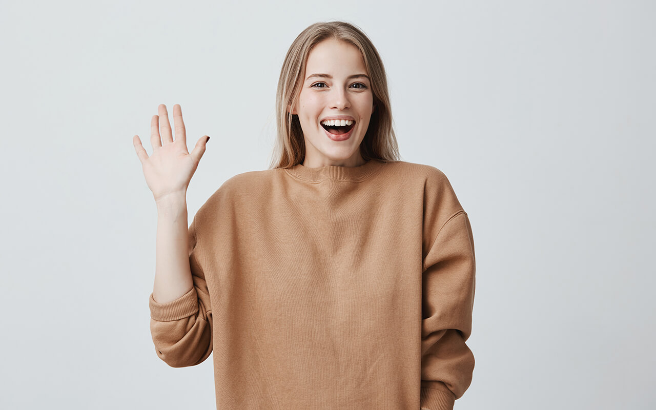 Friendly woman waving