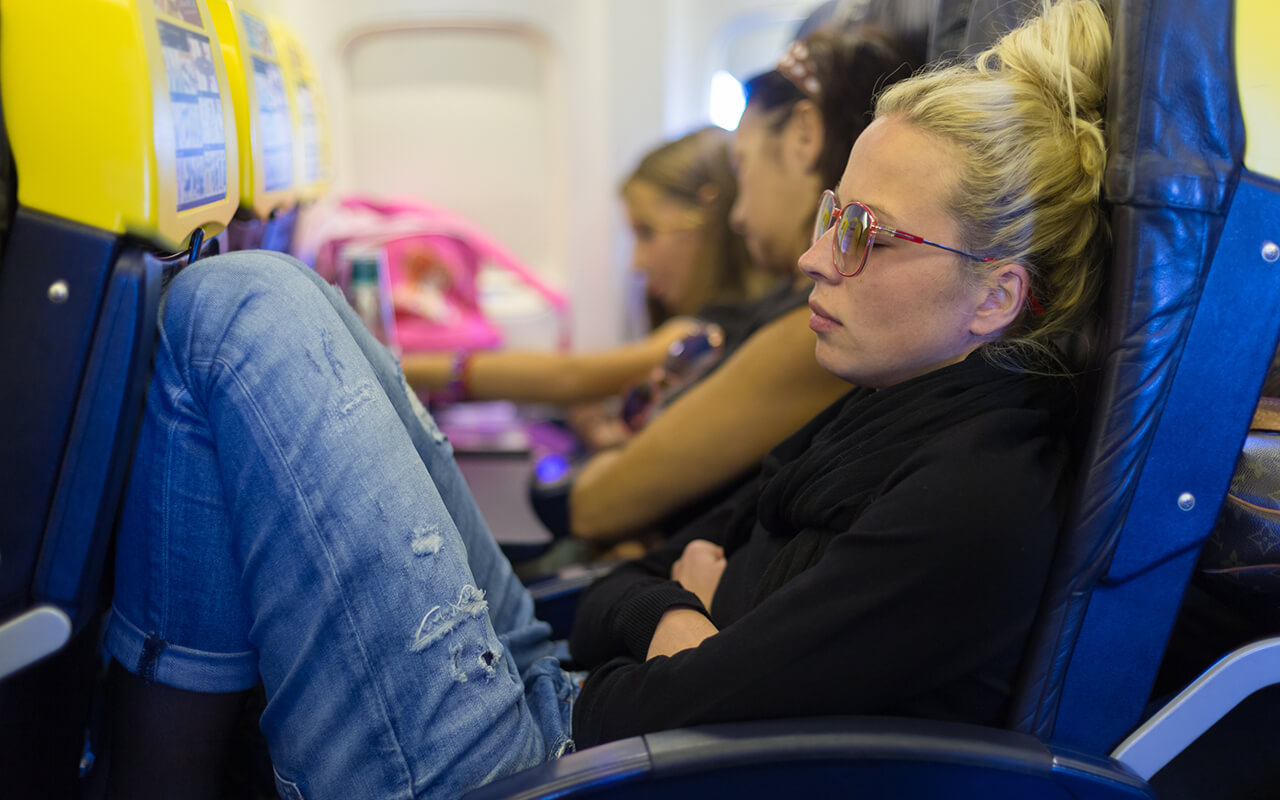 Woman feeling sick on an airplane