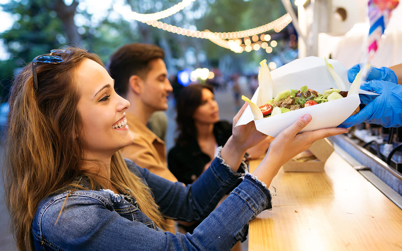 Woman getting food at a taco truck
