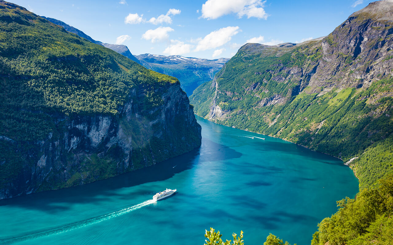 Cruise ship passing by mountains