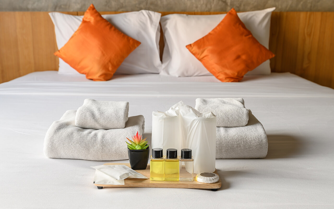 Hotel bed with amenities on it