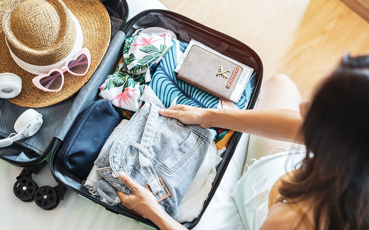 Woman packing her suitcase for travel