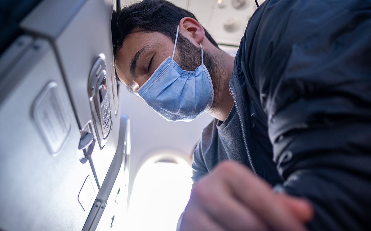 Man feeling sick on an airplane