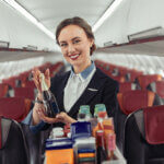 flight attendant serving drinks on an airplane