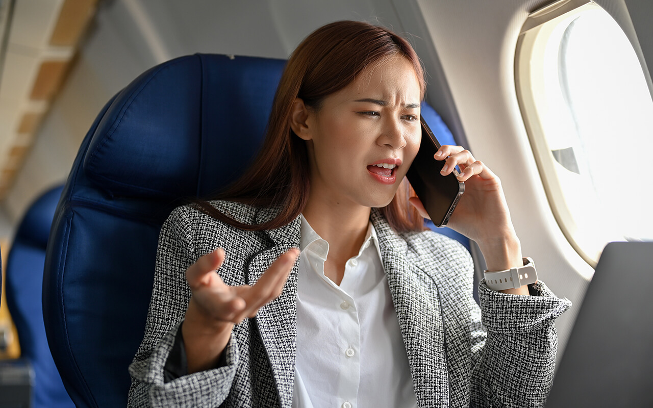 Woman yelling on phone on a plane