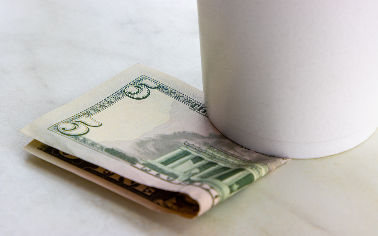 Tip beneath a coffee mug