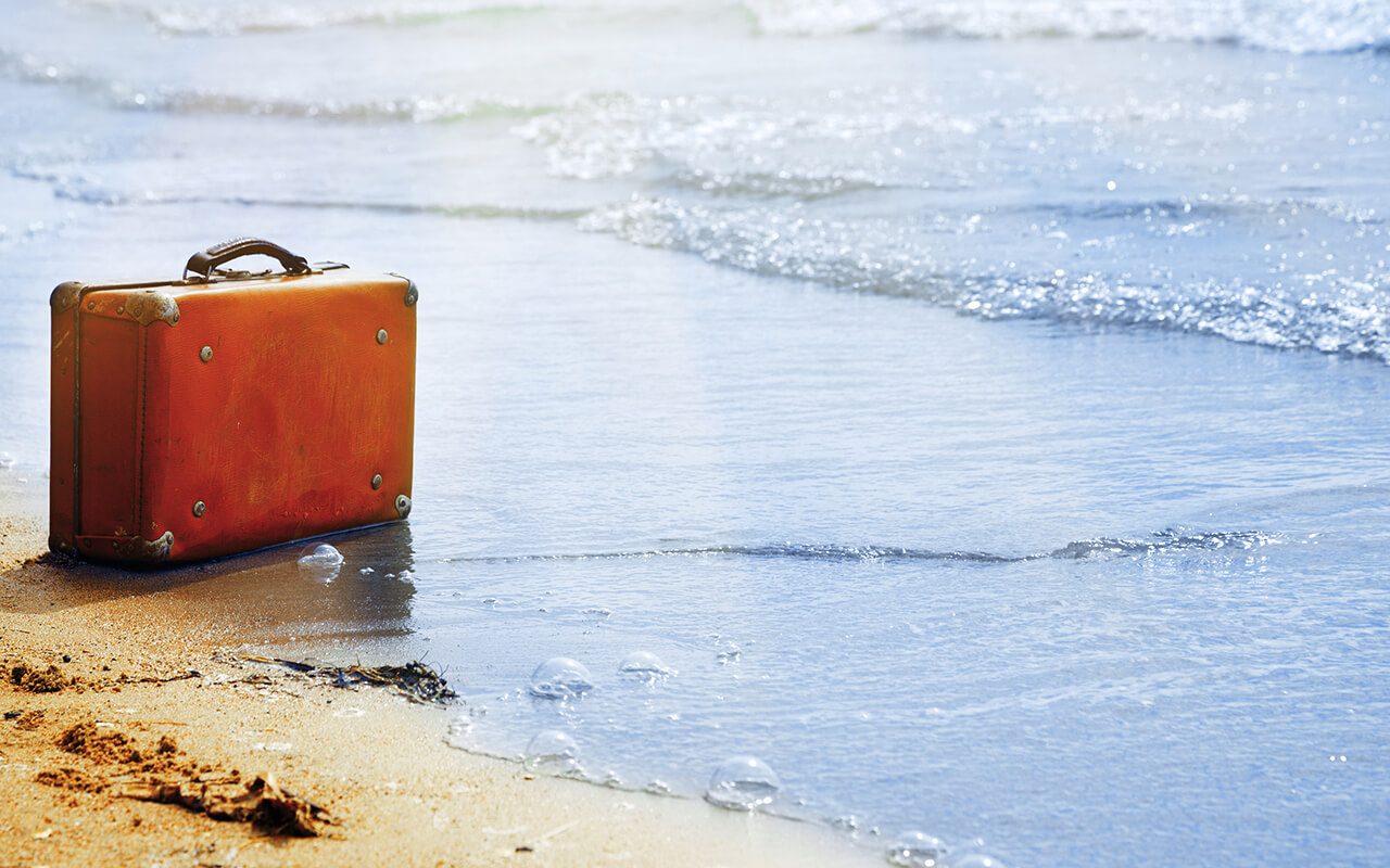 Abandoned luggage on the beach