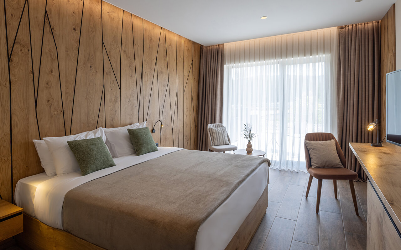 Clean hotel room with bed and chairs