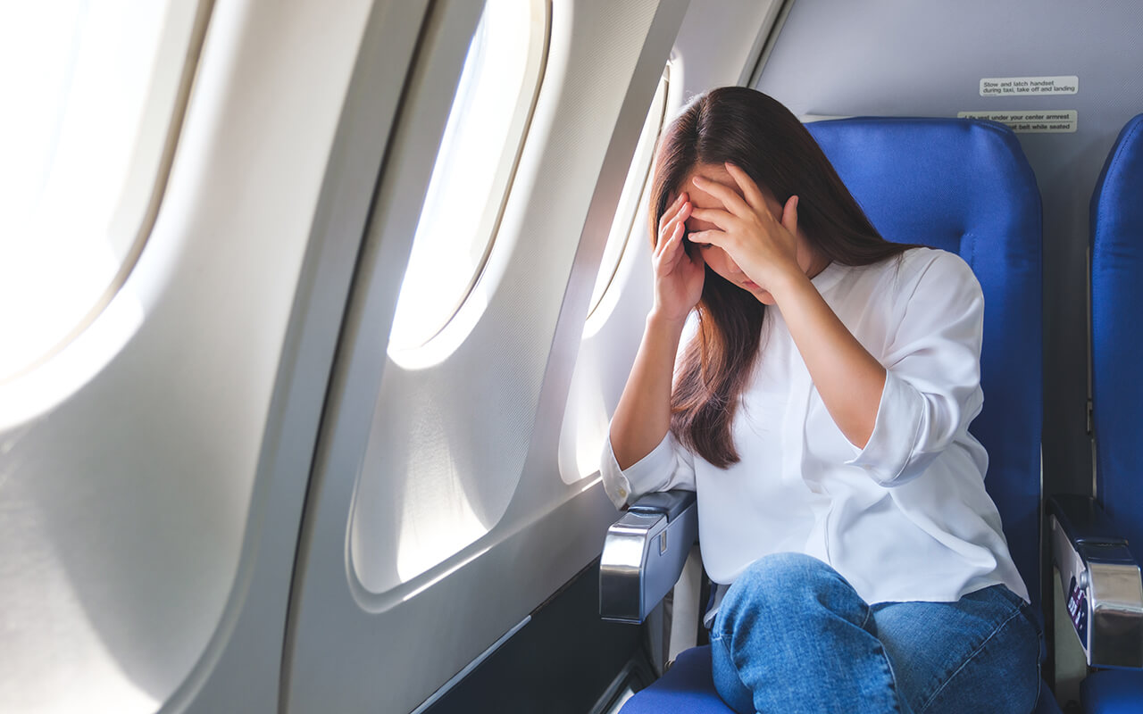 Woman feeling sick on an airplane