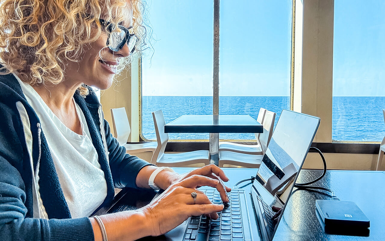 Woman on her laptop on a cruise ship