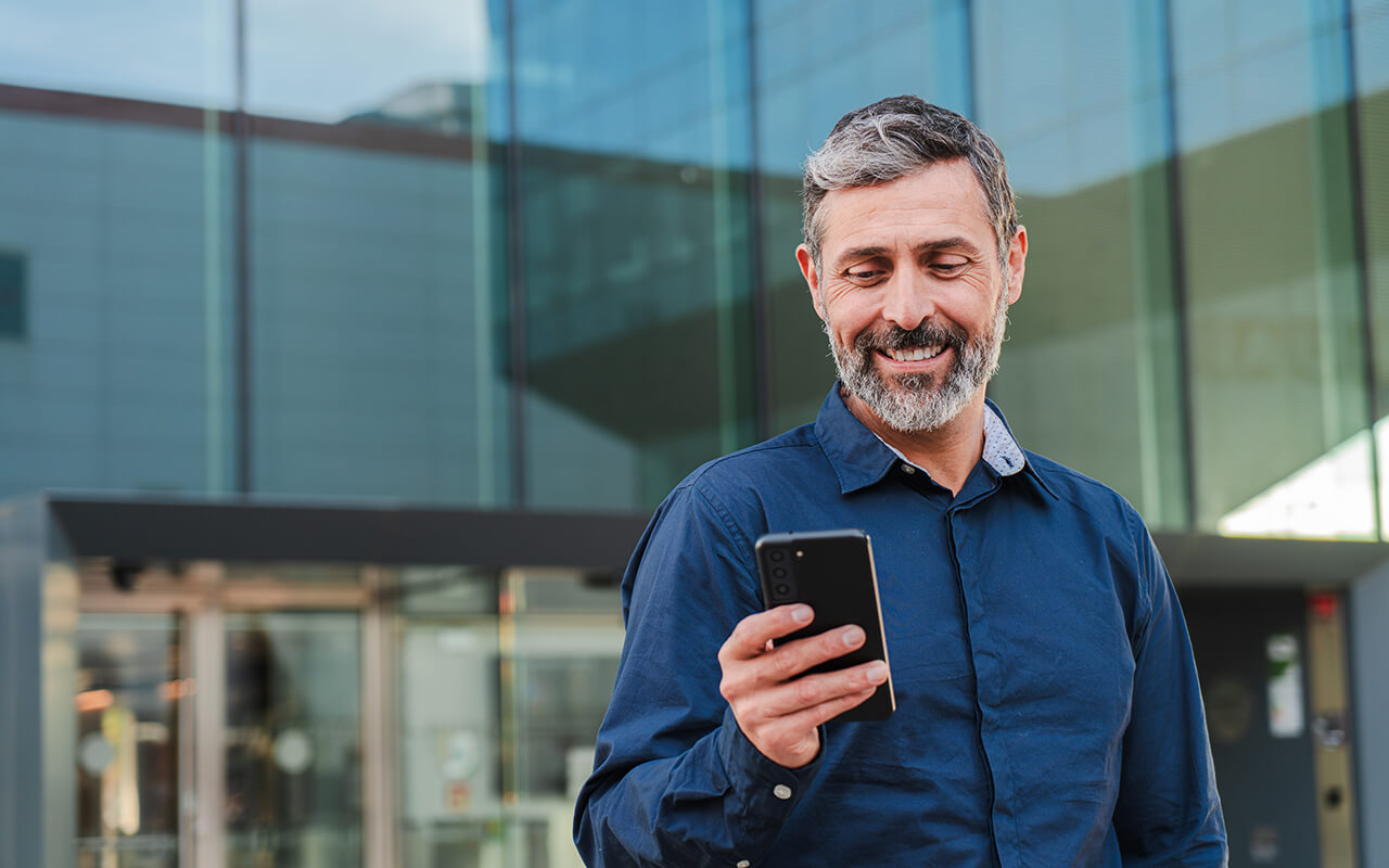 Man looking at his phone outdoors