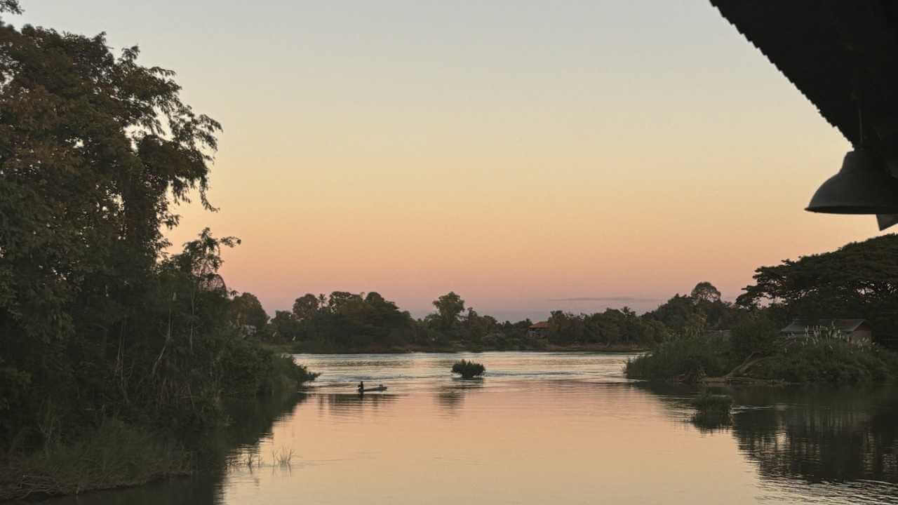 the sun is setting over a body of water