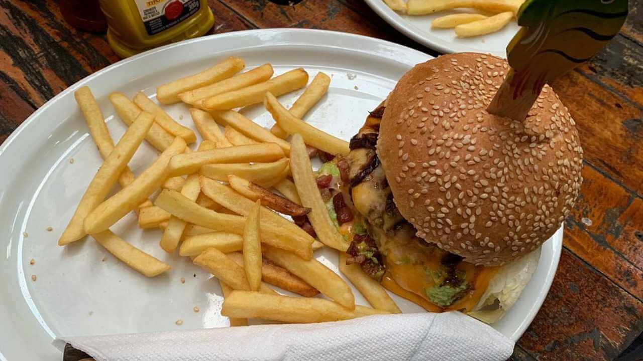 a hamburger and french fries on a white plate