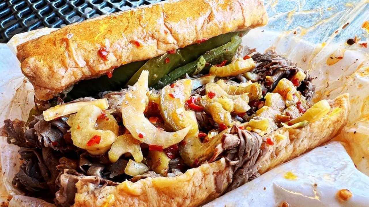 a roast beef sandwich with peppers and onions