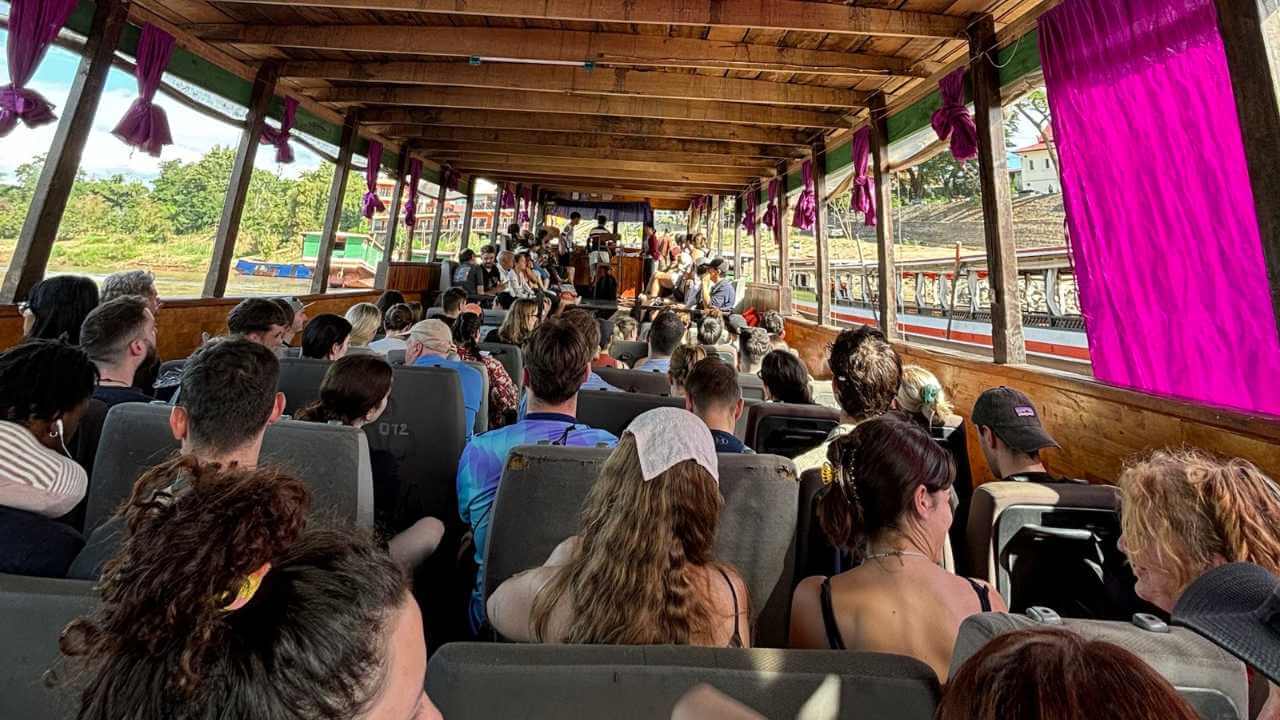 a group of people sitting on the back of a boat