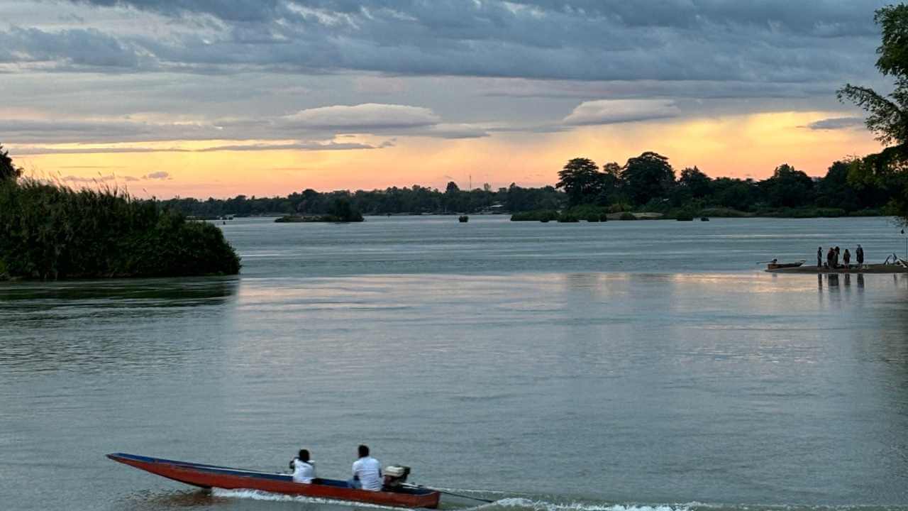 two people in a small boat on the river