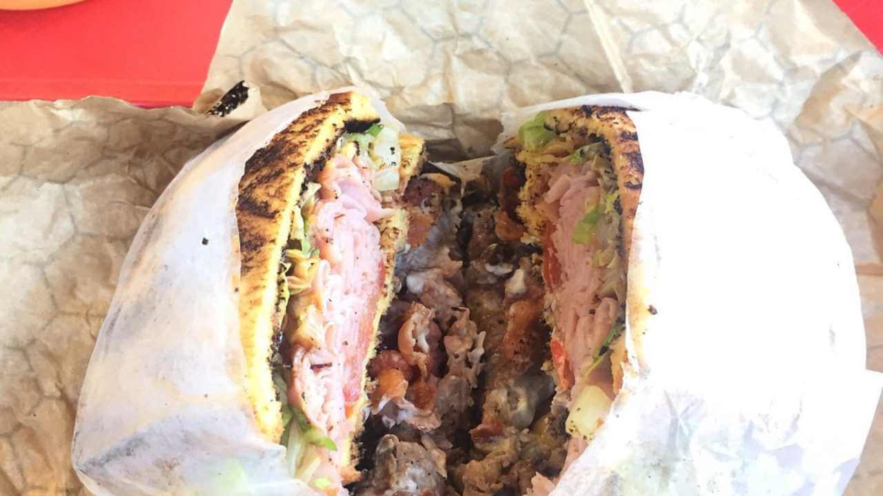 a sandwich cut in half on a piece of paper