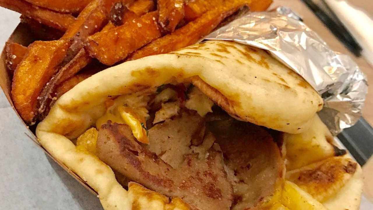 a pita with meat and sweet potato fries