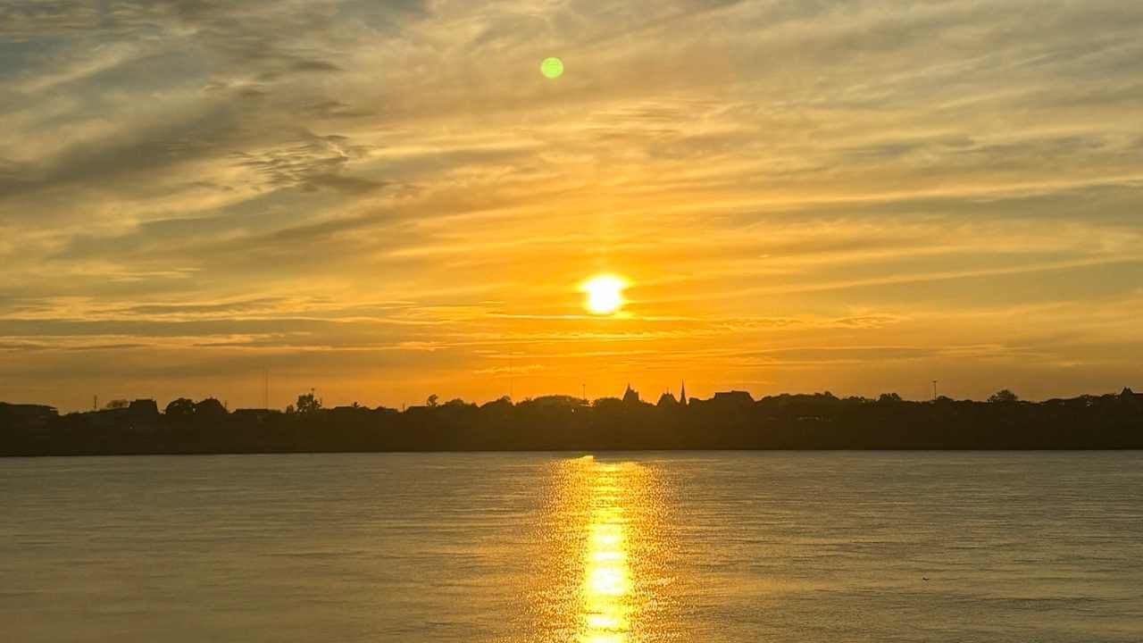 the sun is setting over a body of water