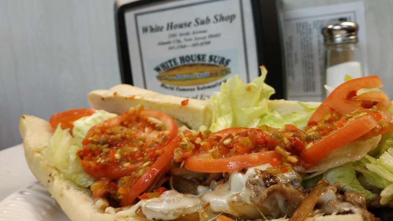 a plate topped with a sandwich with tomatoes and lettuce