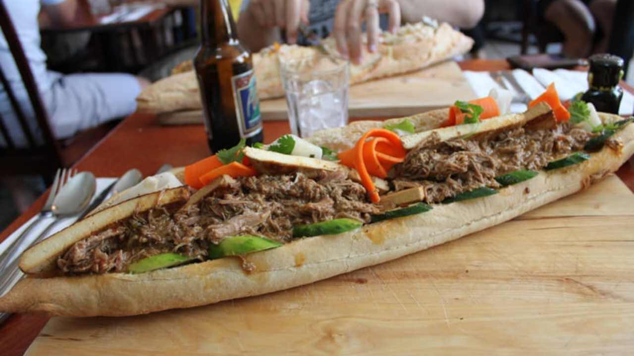 a long sandwich on a wooden cutting board