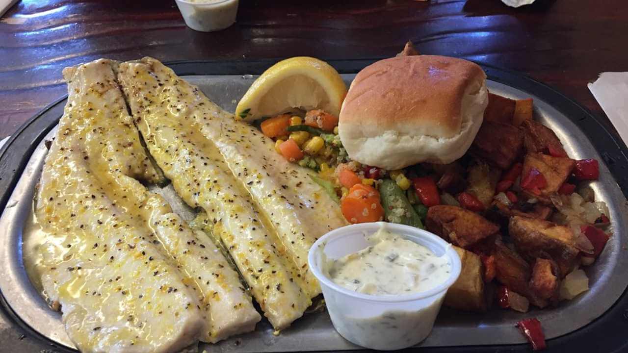 a plate with fish and vegetables on it