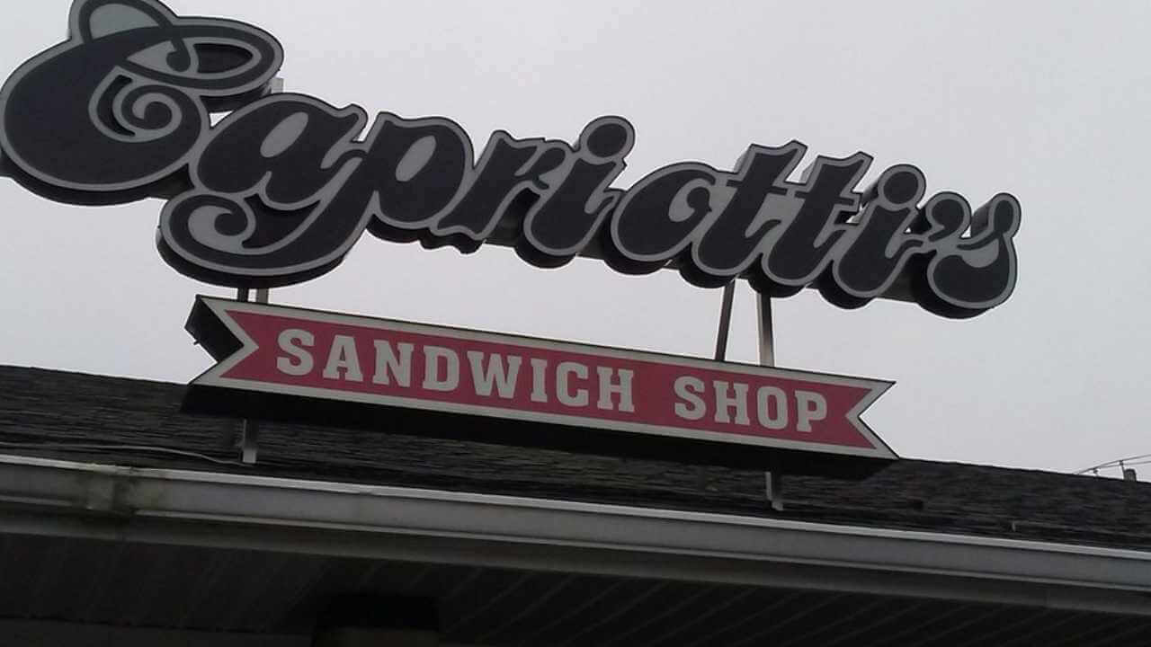 the sign for capriotti's sandwich shop is on top of a building