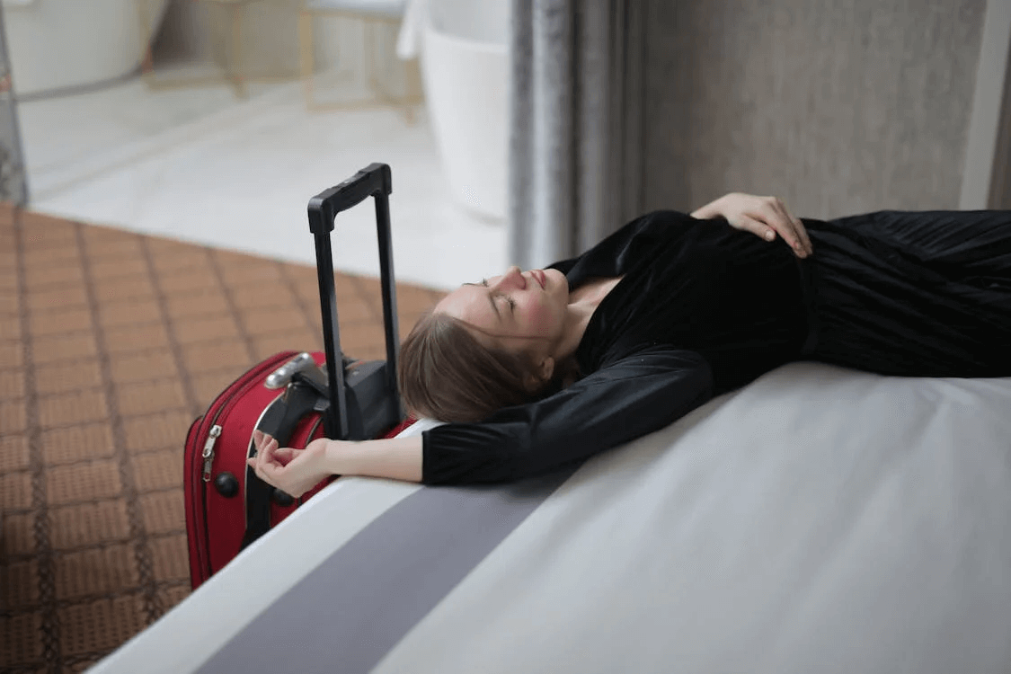 Woman laying on a hotel bed