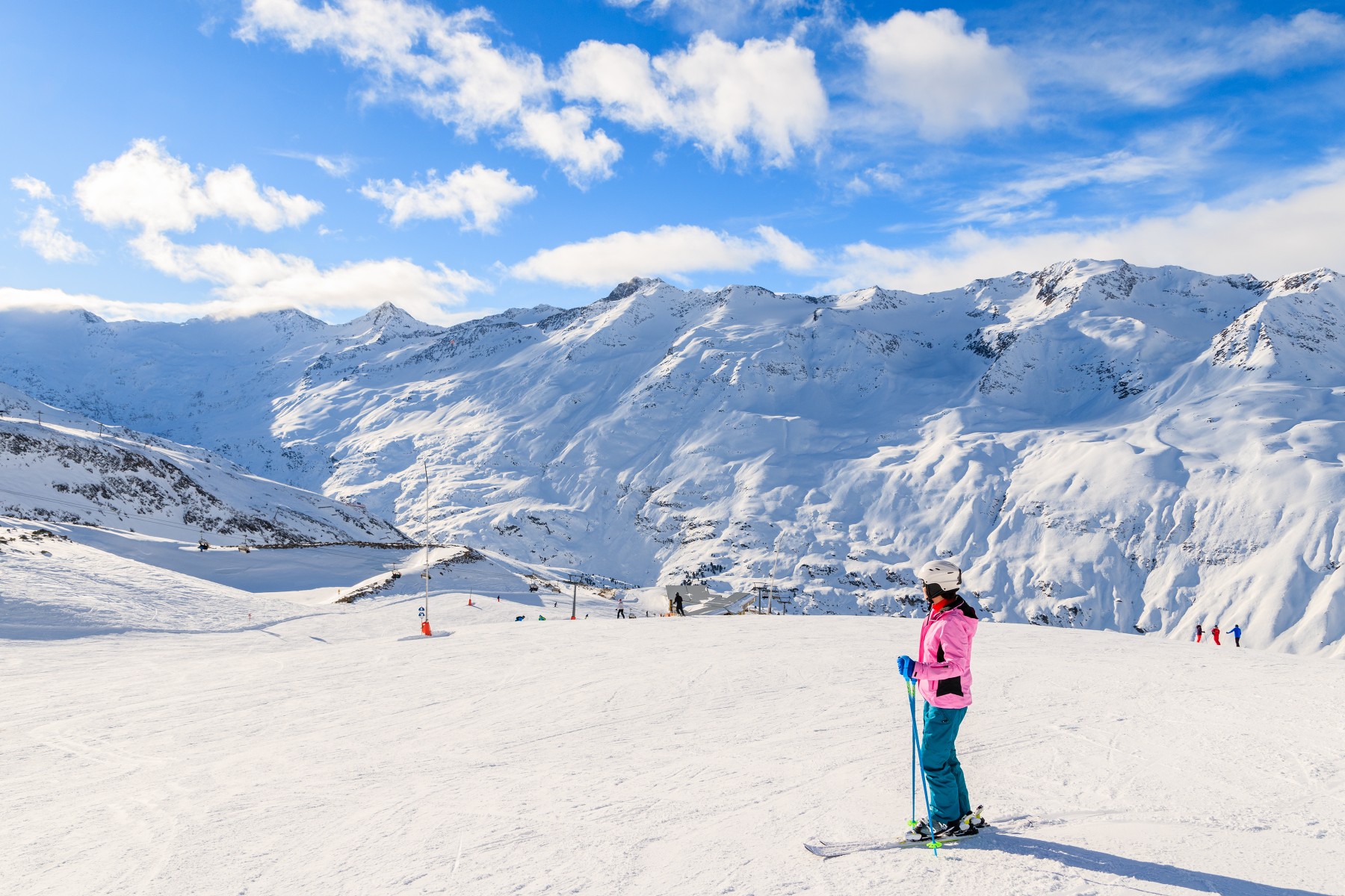 Young woman skier looking at beautiful mountain panorama in winter season, Obergurgl-Hochgurgl ski area, Austria
