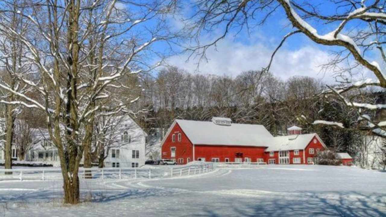 a red barn in the snow metal print