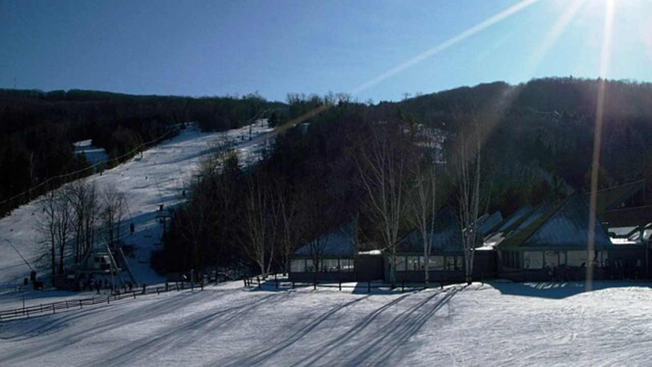 the sun is shining brightly over a ski slope