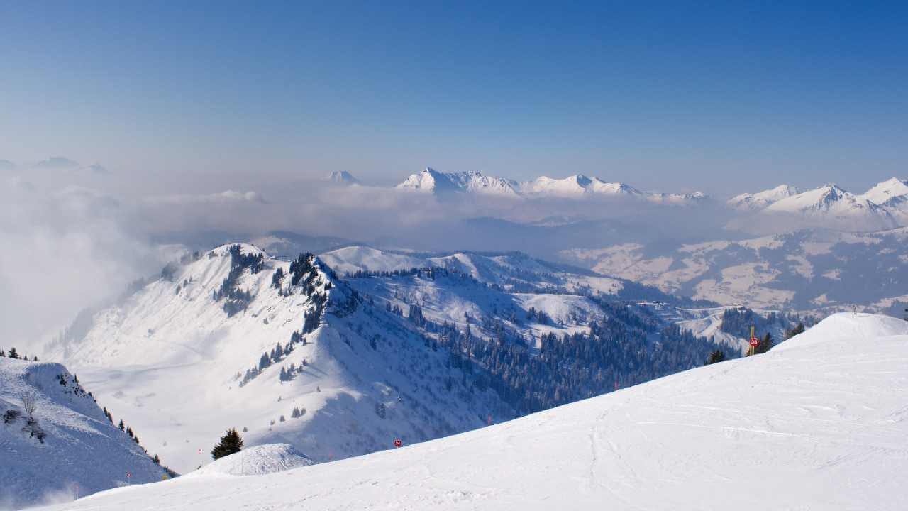 a person is standing on top of a snow covered mountain