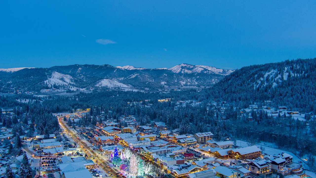 an aerial view of a snowy town at night