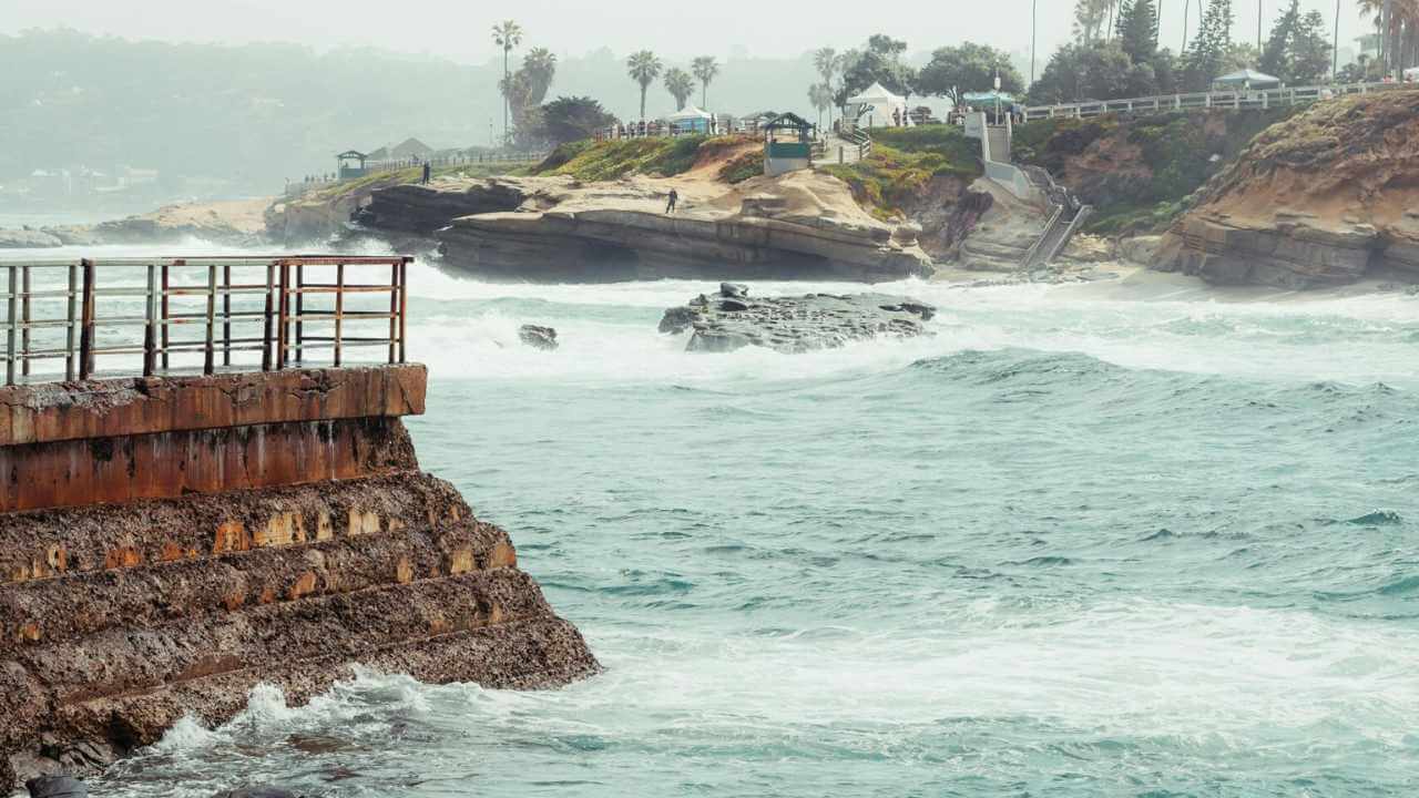 a view of the ocean from a pier on a rainy day