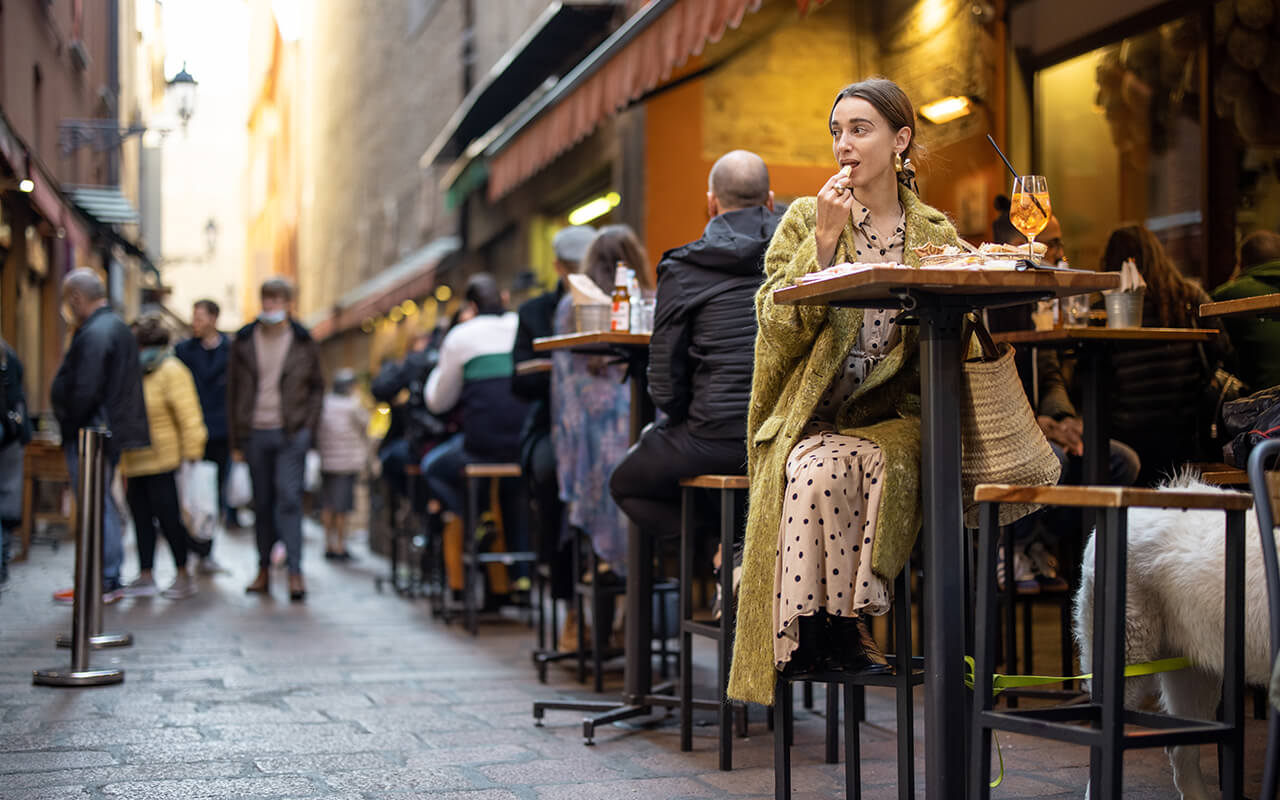 Woman eating at a restaurant in Italy