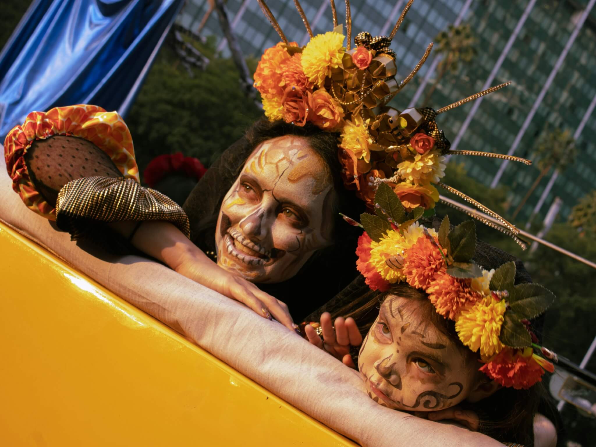 mother and daughter dressed for dia de los muertos