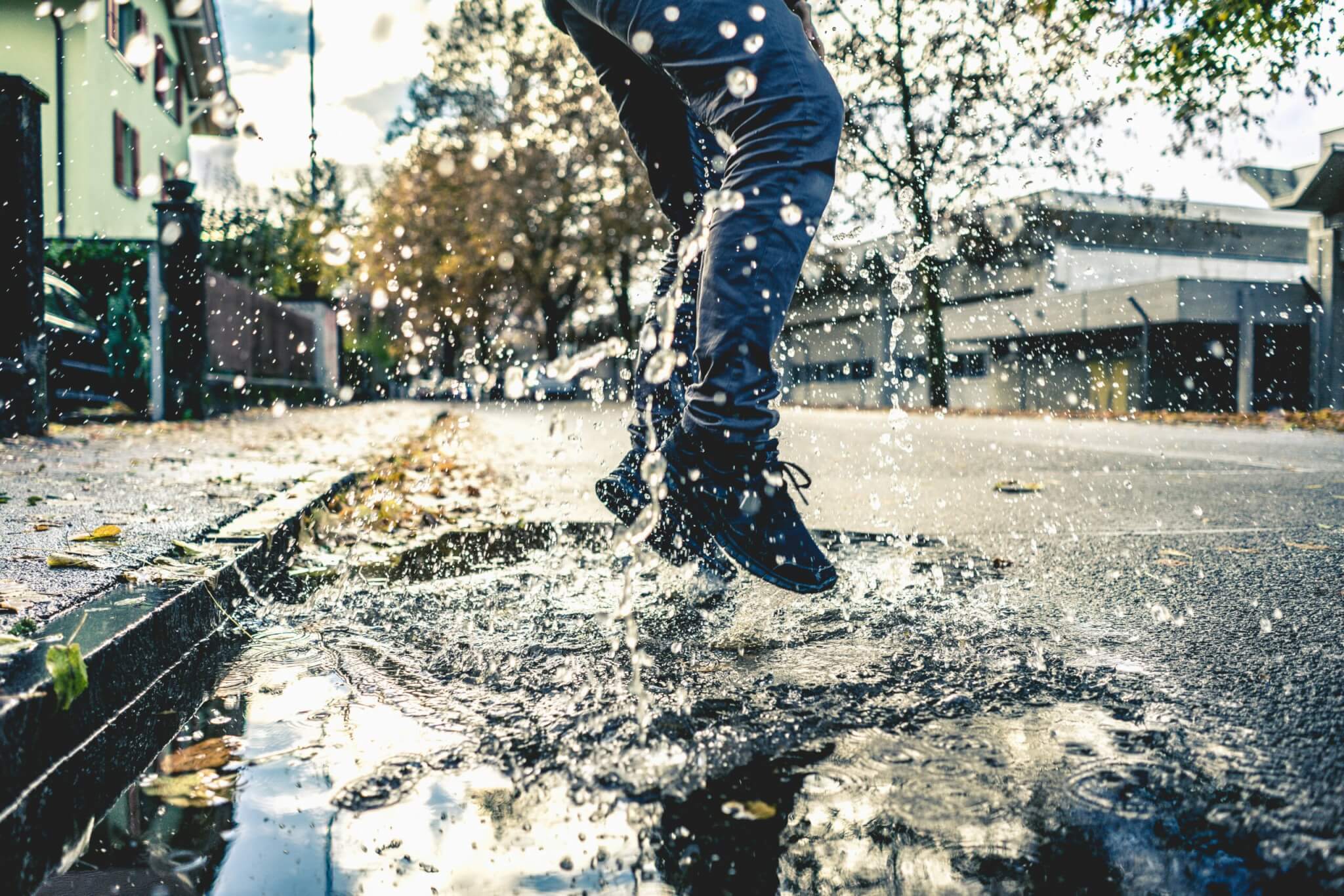 person jumping in a puddle making a splash
