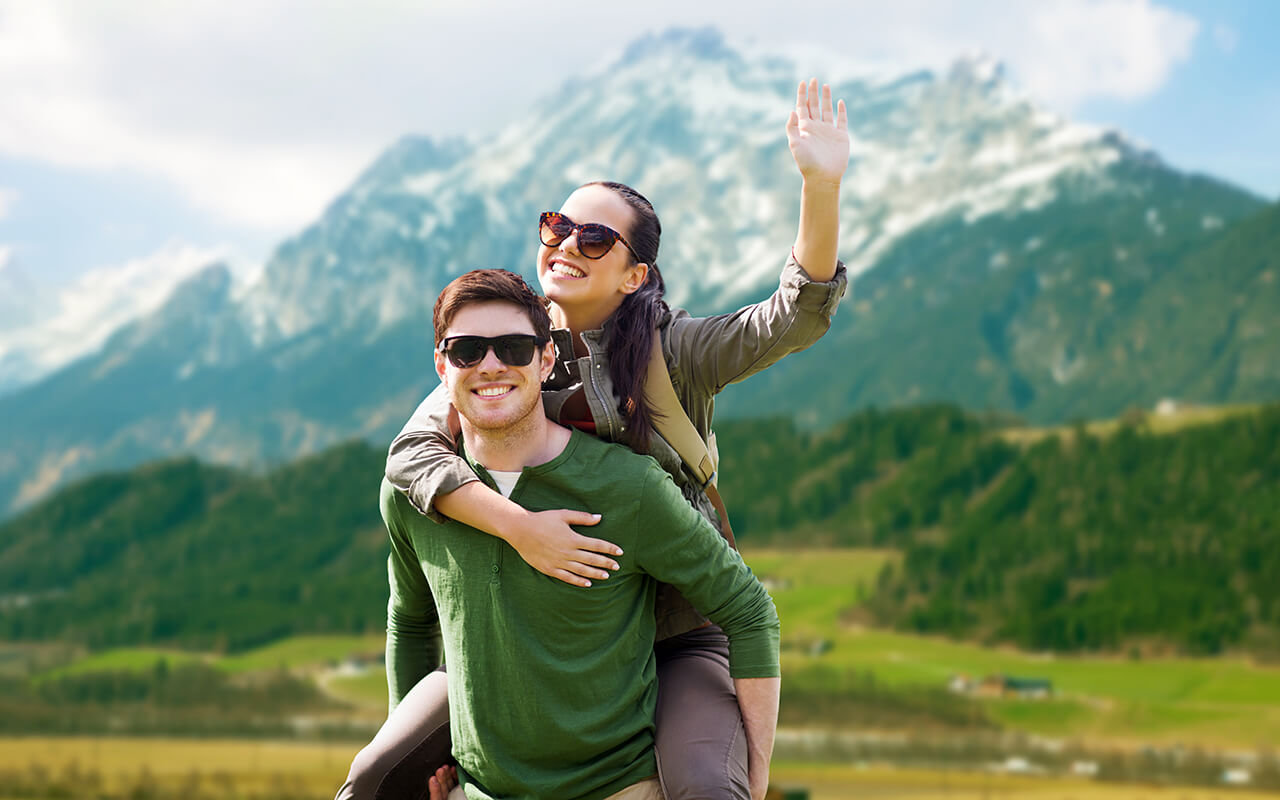 Tourists taking a photo in front of a mountain