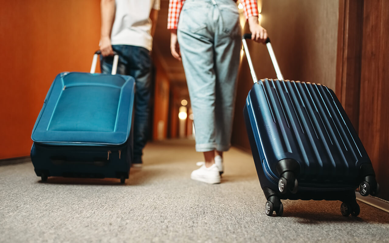 Couple in a hotel hallway with luggage