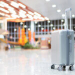 Silver suitcase at airport terminal representing luggage security